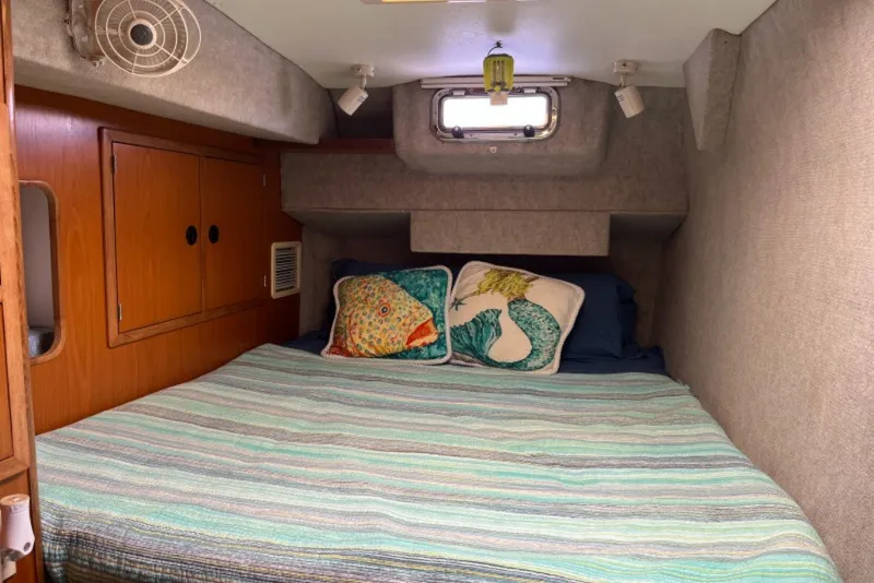 Slide: The Image of Cozy cabin interior of 2004 Manta 42 MkII with striped bedding and decorative pillows. - 20