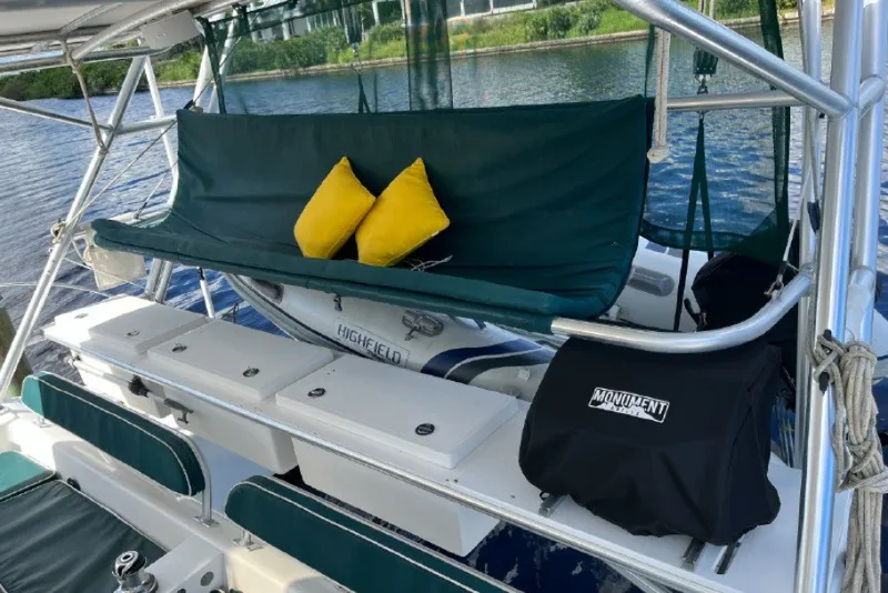 Slide: The Image of 2004 Manta 42 MkII yacht deck with seating, yellow cushions, and storage compartments. - 9