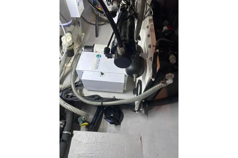 Slide: The Image of Engine compartment of a 2004 Manta 42 MkII sailboat with various mechanical components. - 51