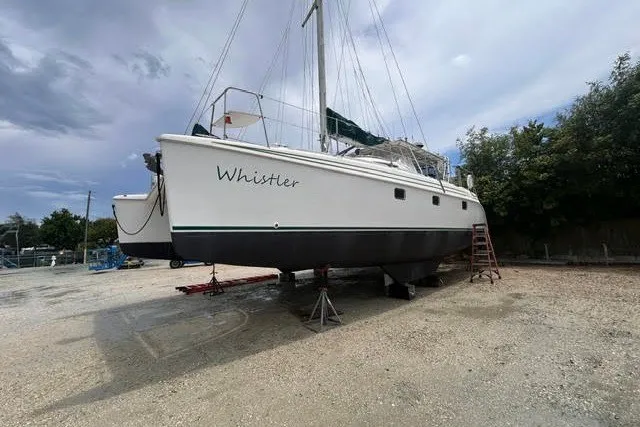 Slide: The Image of 2004 Manta 42 MkII catamaran named "Whistler" on dry dock, overcast sky. - 50
