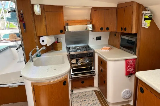 Slide: The Image of 2004 Manta 42 MkII yacht kitchen with wood cabinetry and modern appliances. - 25