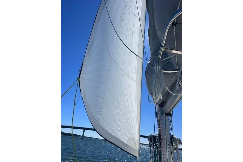 Slide: The Image of Sailing on a 2004 Manta 42 MkII catamaran with full sails against a clear blue sky. - 71