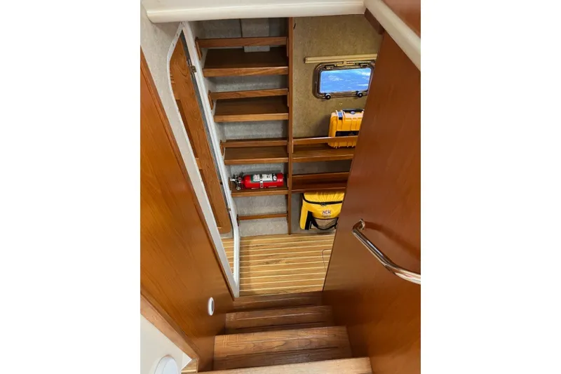 Slide: The Image of Interior stairs of 2004 Manta 42 MkII yacht with wooden finish and safety equipment. - 50