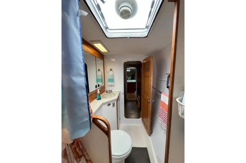 Slide: The Image of Bathroom interior of 2004 Manta 42 MkII yacht, featuring skylight and wooden accents. - 37