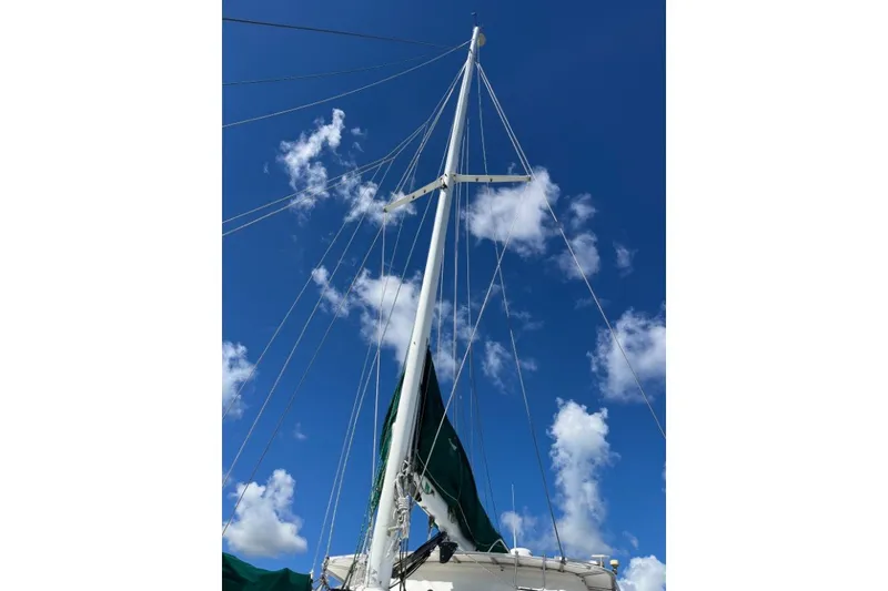 Slide: The Image of Sailboat mast of 2004 Manta 42 MkII against a clear blue sky with clouds. - 13
