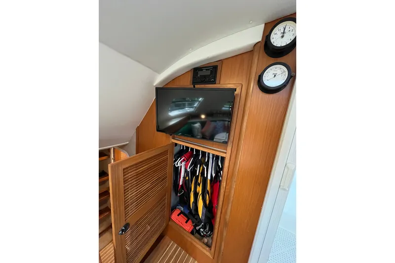 Slide: The Image of Interior of 2004 Manta 42 MkII yacht with TV, closet, and clocks. - 48