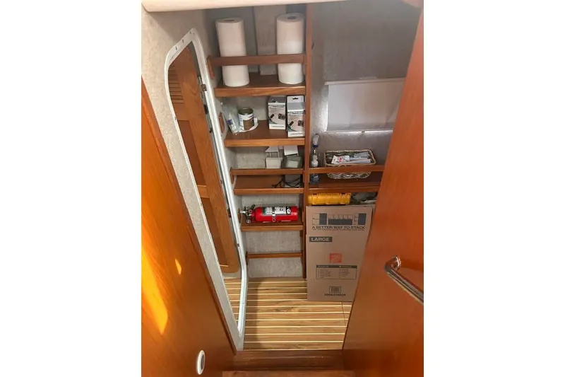 Slide: The Image of Storage area inside a 2004 Manta 42 MkII yacht with shelves and supplies. - 27