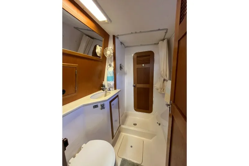 Slide: The Image of Bathroom interior of 2004 Manta 42 MkII yacht, featuring sink, toilet, and shower area. - 39