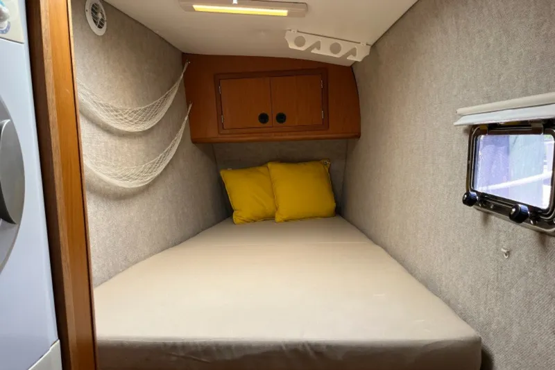 Slide: The Image of Cozy cabin interior of 2004 Manta 42 MkII with yellow pillows and porthole window. - 21