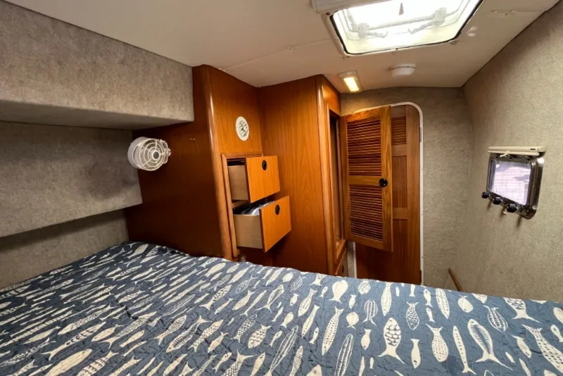 Slide: The Image of Cozy cabin interior of 2004 Manta 42 MkII with nautical-themed bedding and wooden accents. - 19