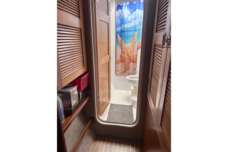 Slide: The Image of Bathroom interior of 2004 Manta 42 MkII yacht with starfish shower curtain. - 17