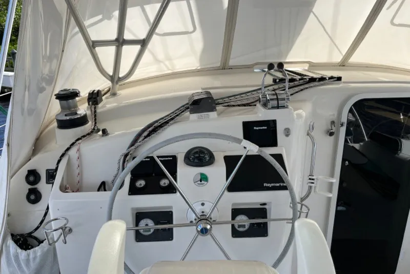 Slide: The Image of Cockpit of 2004 Manta 42 MkII sailboat with steering wheel and navigation instruments. - 12