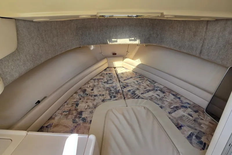 Slide: The Image of 2003 Grady-White Sailfish 282 cabin interior with beige seating and patterned flooring. - 19