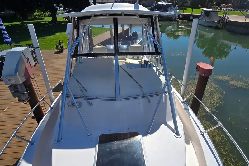Slide: The Image of 2003 Grady-White Sailfish 282 boat docked, showcasing spacious deck and sleek design. - 15