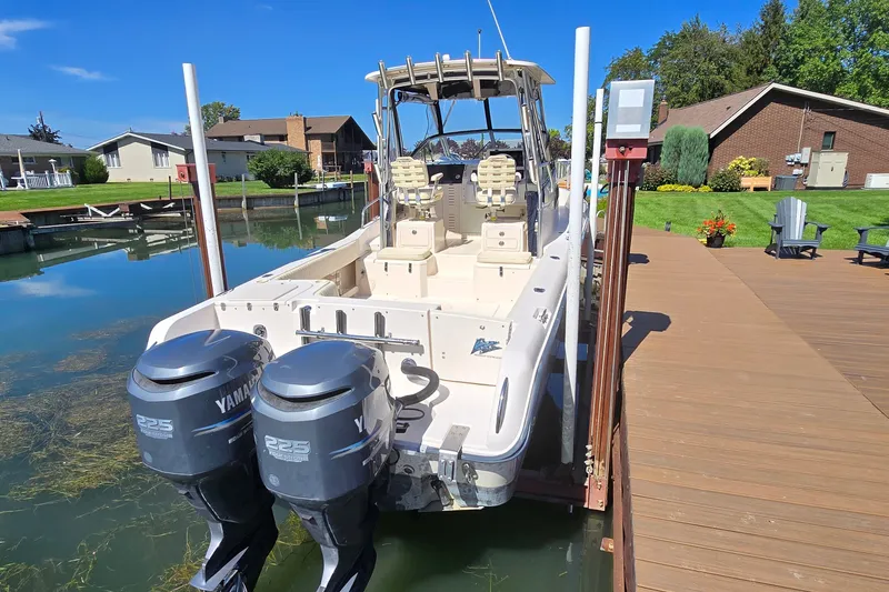 Slide: The Image of 2003 Grady-White Sailfish 282 boat with twin Yamaha 225 engines docked by a lakeside. - 3