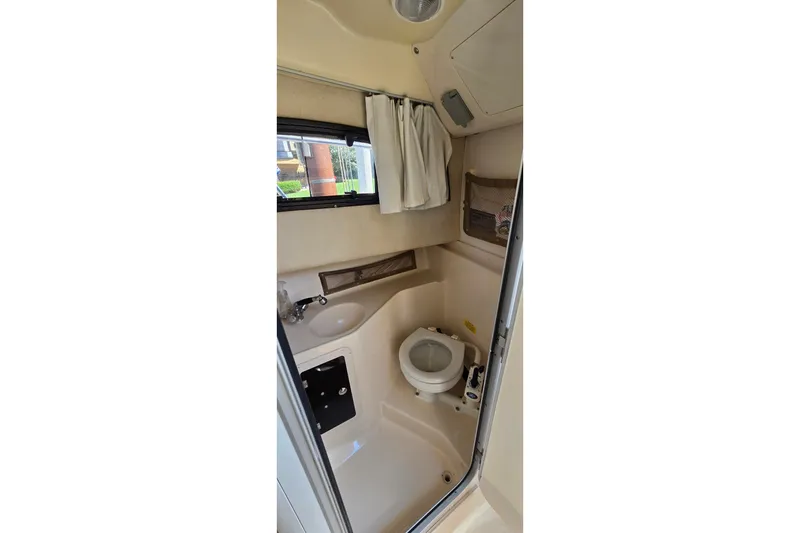 Slide: The Image of 2003 Grady-White Sailfish 282 boat bathroom interior with toilet and sink. - 23
