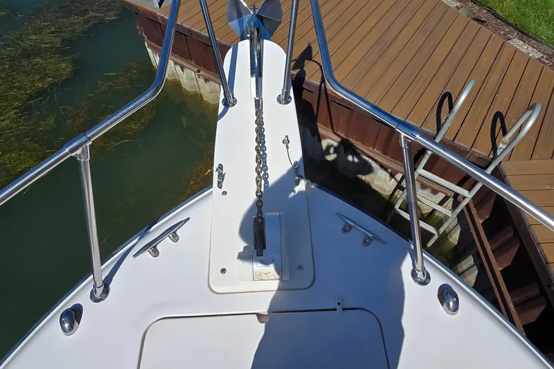 Slide: The Image of Bow view of 2003 Grady-White Sailfish 282 at dock, featuring anchor and railing. - 16