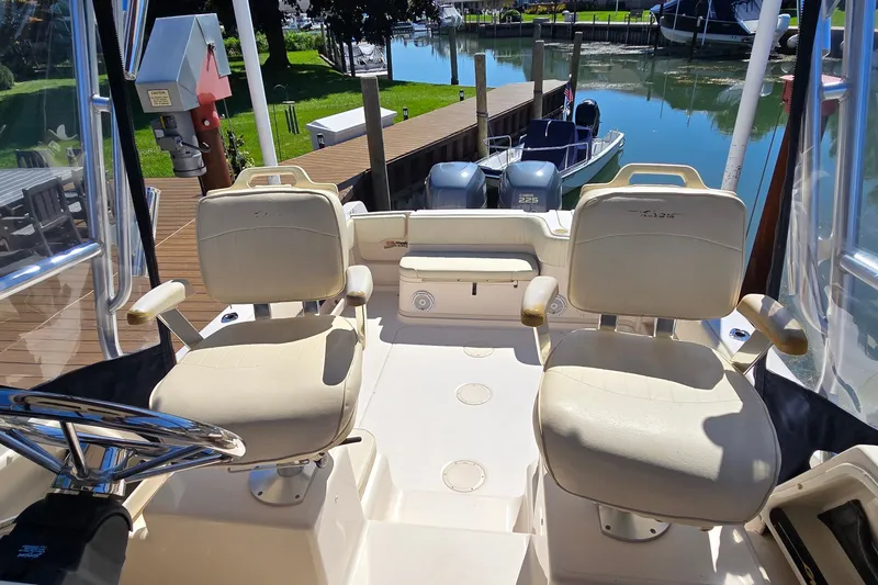 Slide: The Image of 2003 Grady-White Sailfish 282 boat interior with dual seats and dock view. - 27