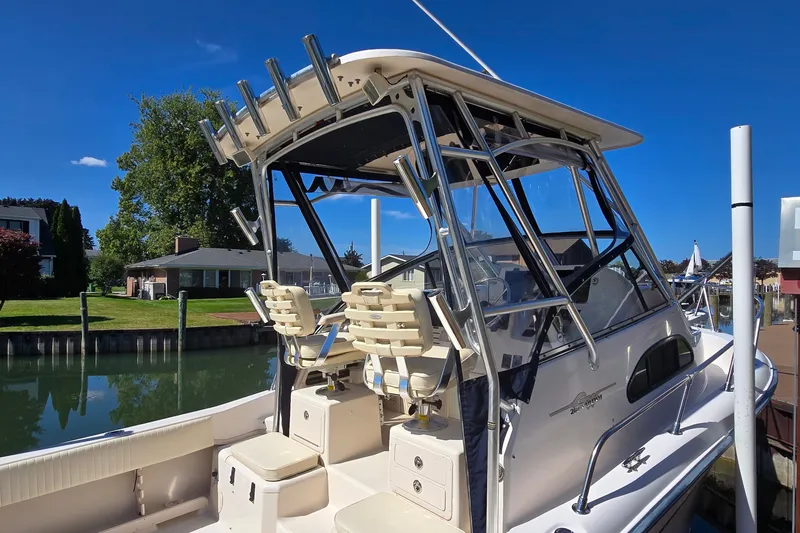 Slide: The Image of 2003 Grady-White Sailfish 282 boat docked, featuring dual seats and sturdy frame. - 5