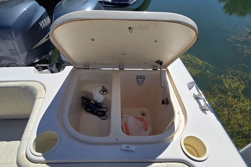 Slide: The Image of Open storage compartment on 2003 Grady-White Sailfish 282 boat with accessories inside. - 30