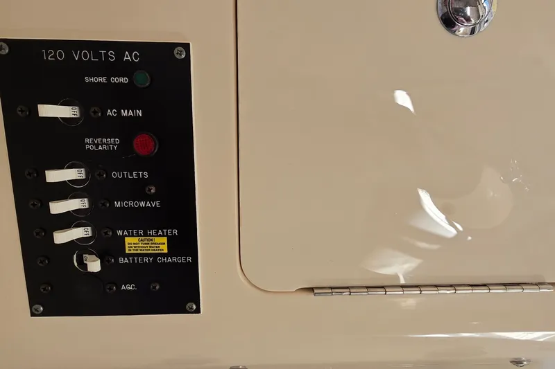 Slide: The Image of Electrical panel on a 2003 Grady-White Sailfish 282 boat, showing 120 volts AC controls. - 25