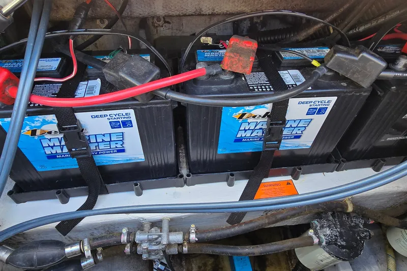 Slide: The Image of Marine batteries in a 2003 Grady-White Sailfish 282 boat, secured with straps. - 33
