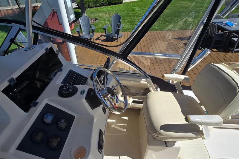 Slide: The Image of 2003 Grady-White Sailfish 282 helm with steering wheel and control panel. - 11