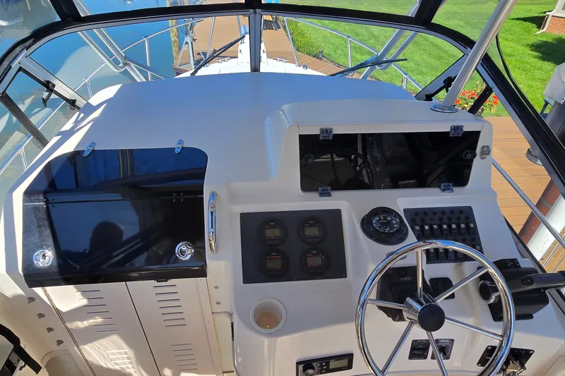 Slide: The Image of Helm of 2003 Grady-White Sailfish 282 boat with steering wheel and control panel. - 14