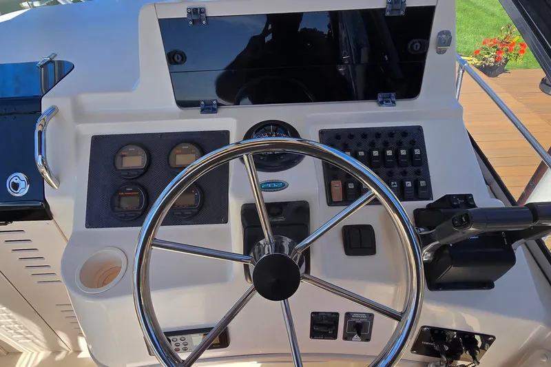 Slide: The Image of Helm of 2003 Grady-White Sailfish 282 boat with steering wheel and control panel. - 8
