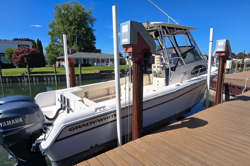 The Image of 2003 Grady-White Sailfish 282 boat docked with Yamaha engines, sunny day. - 2