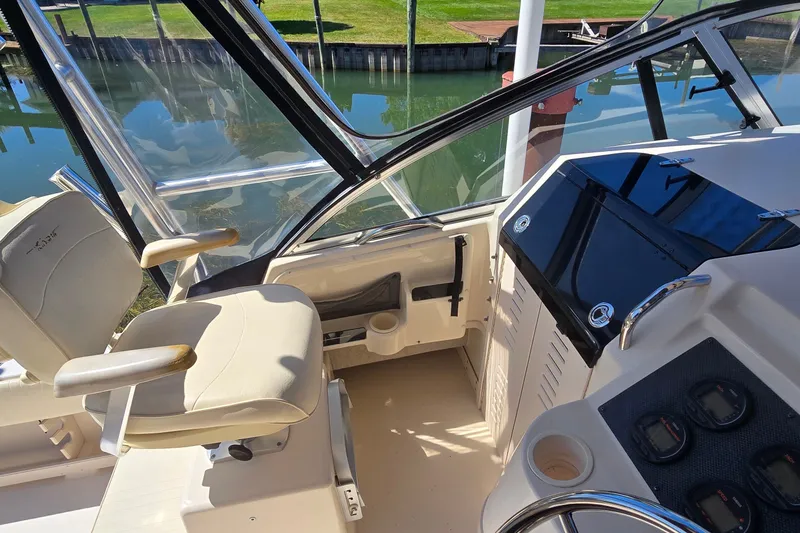 Slide: The Image of 2003 Grady-White Sailfish 282 boat cockpit with helm, seating, and water view. - 9