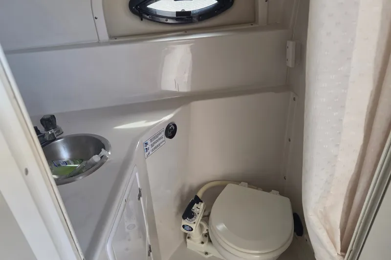 Slide: The Image of 1999 Four Winns 258 Vista boat bathroom with sink and toilet. - 16