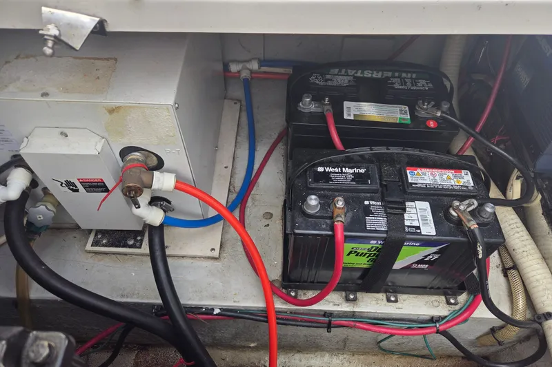 Slide: The Image of 1999 Four Winns 258 Vista boat battery compartment with West Marine batteries and wiring. - 22