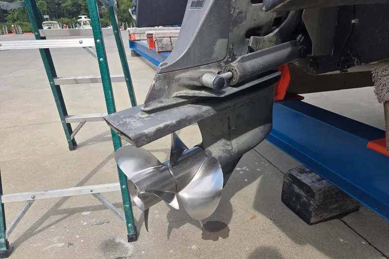Slide: The Image of 1999 Four Winns 258 Vista boat propeller on display with ladder nearby. - 21