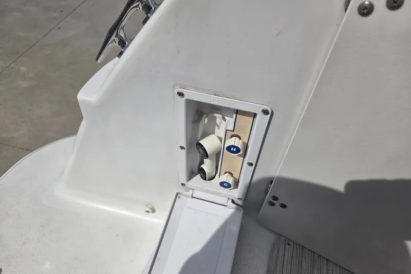 Slide: The Image of 1999 Four Winns 258 Vista boat shower controls with hot and cold settings. - 18
