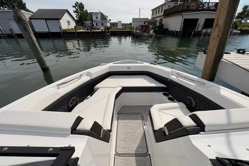 Slide: The Image of 2026 Cobalt R6 Outboard boat interior with sleek seating and waterfront view. - 14