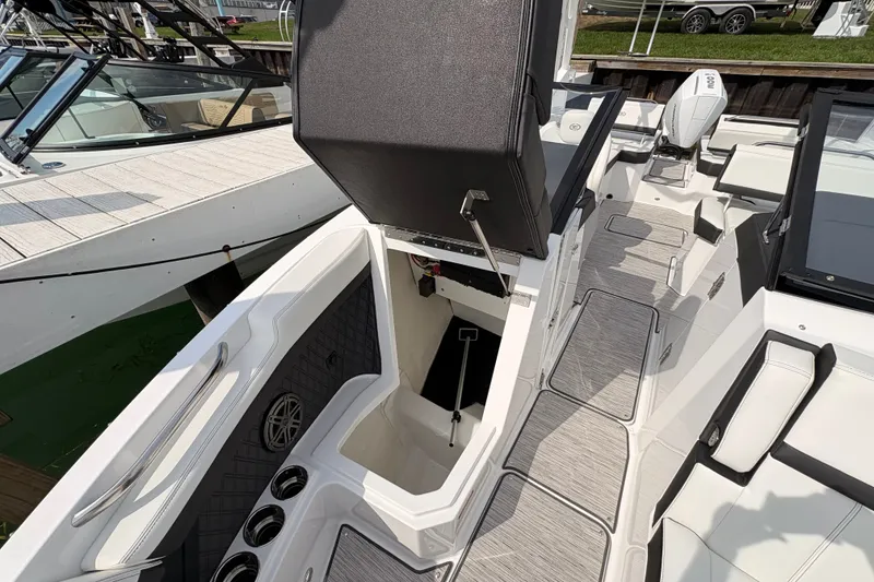 Slide: The Image of 2026 Cobalt R6 Outboard boat interior with open storage compartment and sleek seating. - 16