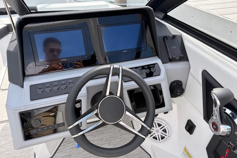 Slide: The Image of 2026 Cobalt R6 Outboard dashboard with dual Garmin displays and modern steering wheel. - 12