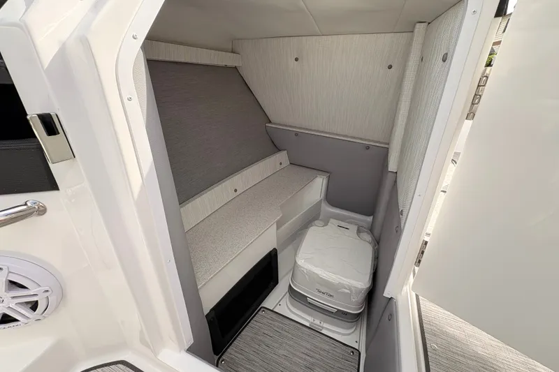 Slide: The Image of 2026 Cobalt R6 Outboard cabin interior with seating and portable toilet. - 13