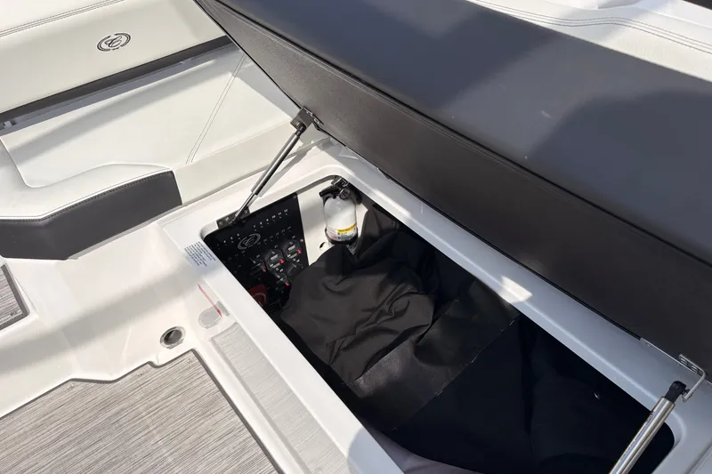 Slide: The Image of Open storage compartment in 2026 Cobalt R6 Outboard boat, featuring interior details and equipment. - 10