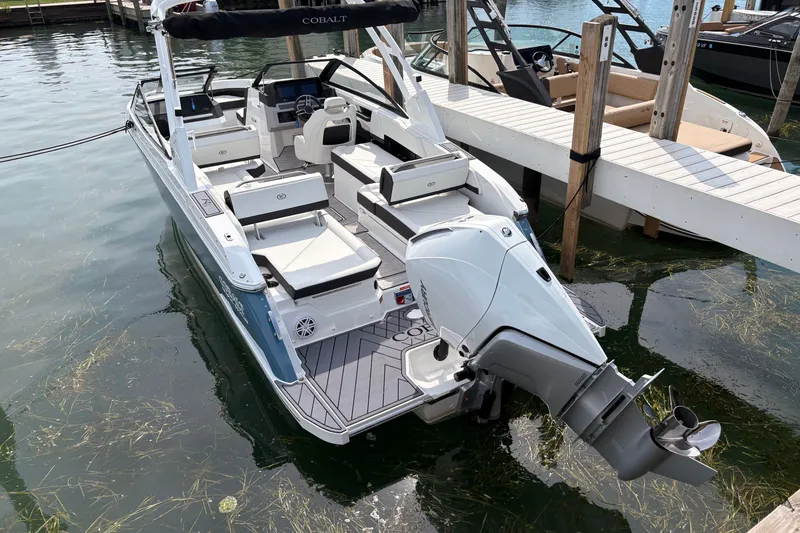 Slide: The Image of 2026 Cobalt R6 Outboard boat docked, featuring sleek design and spacious seating. - 6