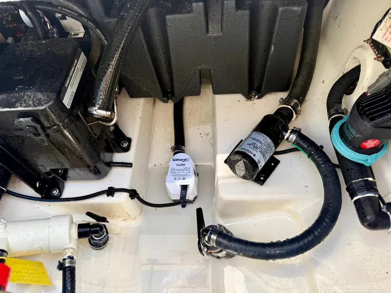 Slide: The Image of Close-up of a 2024 Boston Whaler 250 Outrage engine compartment with hoses and cables. - 36