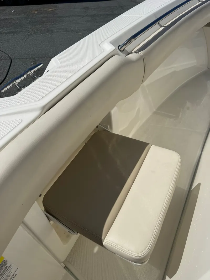 Slide: The Image of A seat in the cockpit of a 2024 Boston Whaler 250 Outrage, featuring a cushioned pad. - 43
