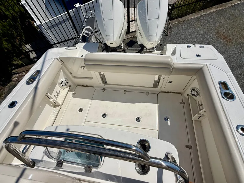 Slide: The Image of The image shows the cockpit of a 2024 Boston Whaler 250 Outrage with dual engines. - 31