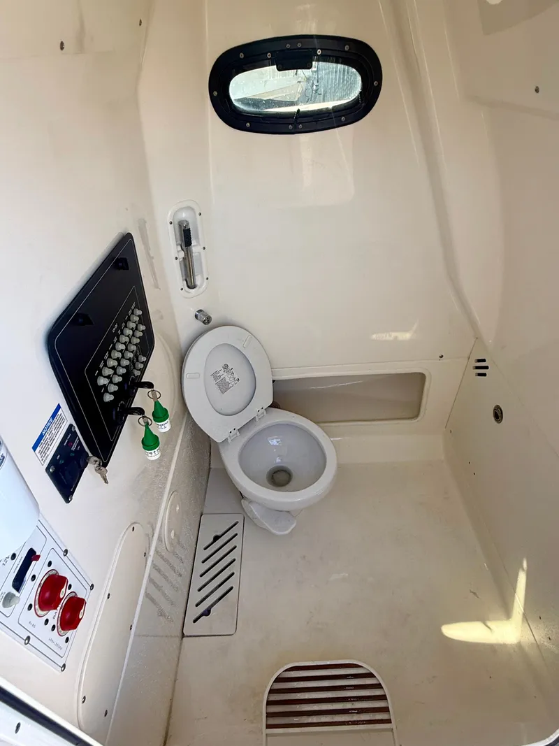 Slide: The Image of Interior view of a boat cabin with a toilet and control panel. - 21