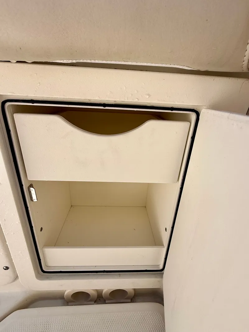 Slide: The Image of An open storage compartment on a boat with a shelf. - 37