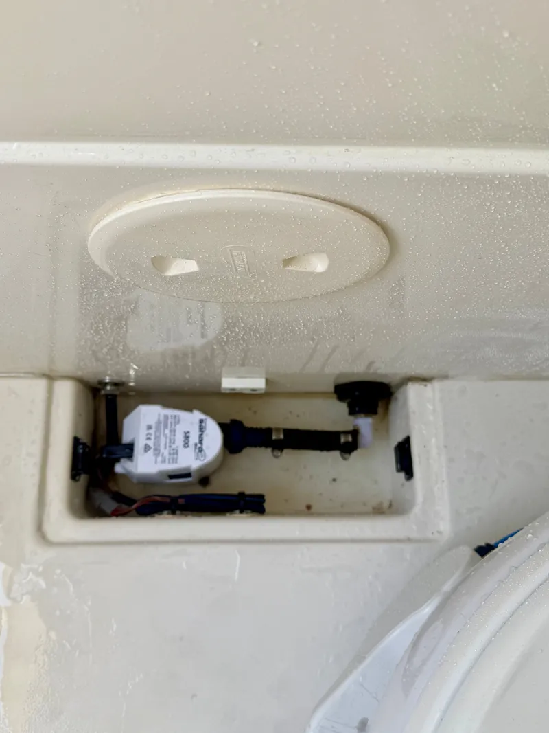 Slide: The Image of Close-up of a boat compartment with a pump and wiring. - 24