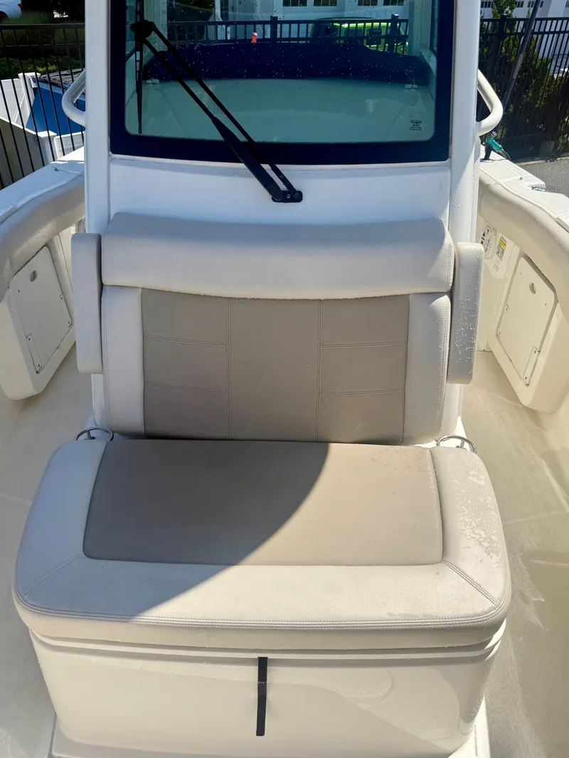 Slide: The Image of The 2024 Boston Whaler 250 Outrage features a comfortable bench seat with cushioned padding and storage underneath. - 27