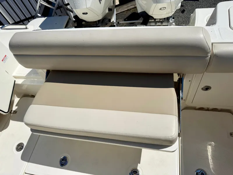Slide: The Image of The 2024 Boston Whaler 250 Outrage features a cushioned bench seat in the aft area. - 32