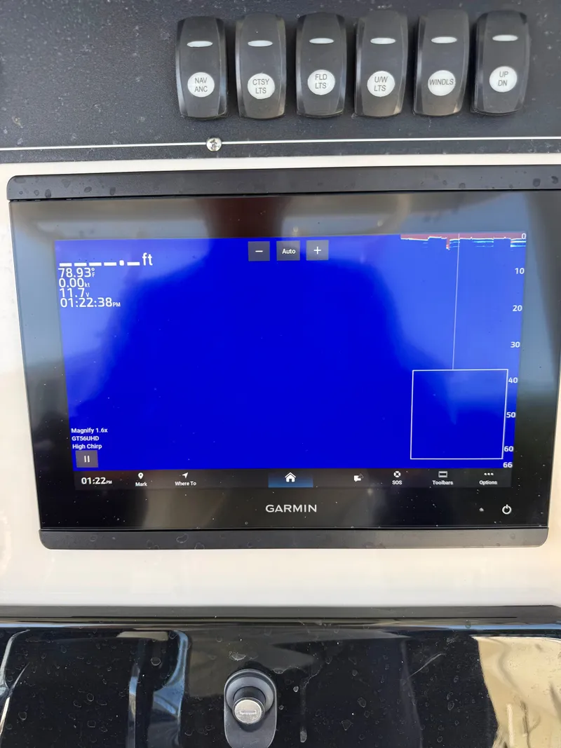 Slide: The Image of A Garmin navigation system on a boat with various switches above it. - 13